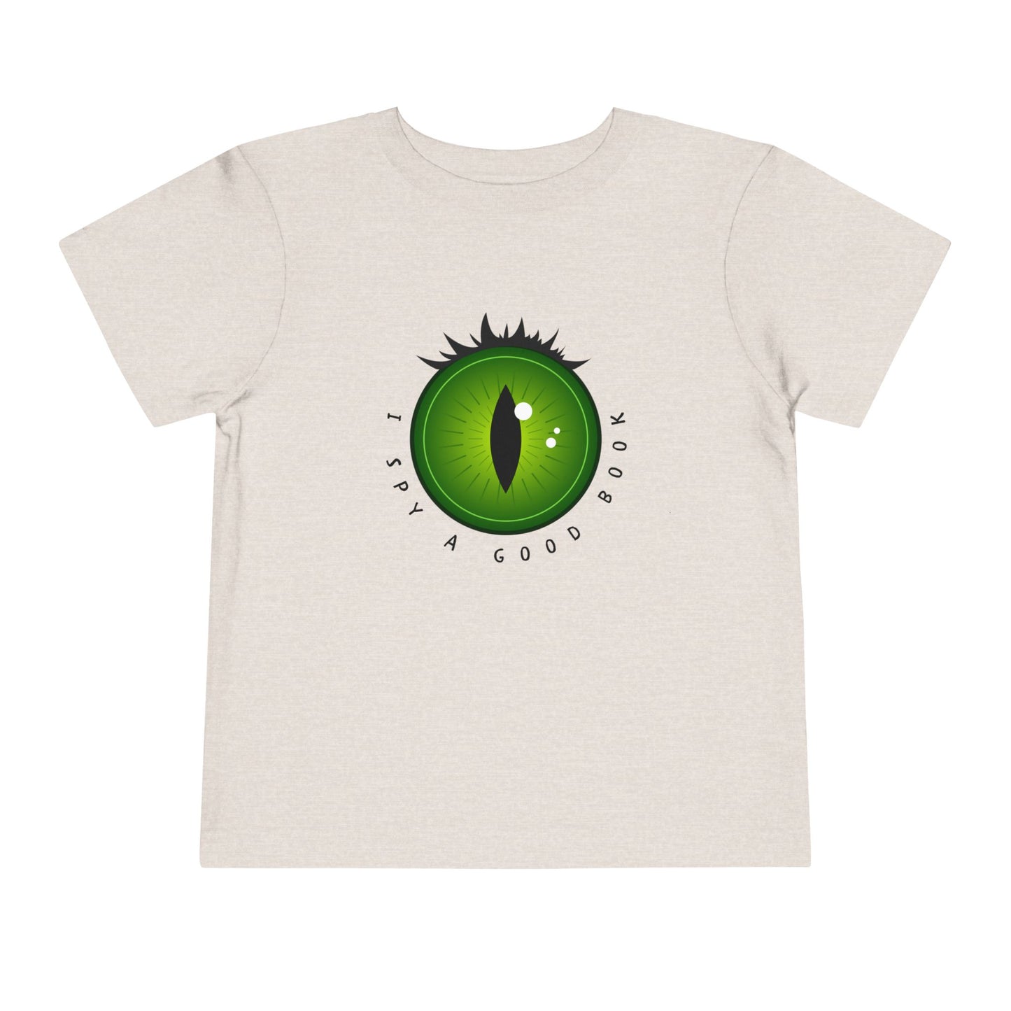 Sandy beige t-shirt with a green dragon eye design and text 'I SPY A GOOD BOOK'
