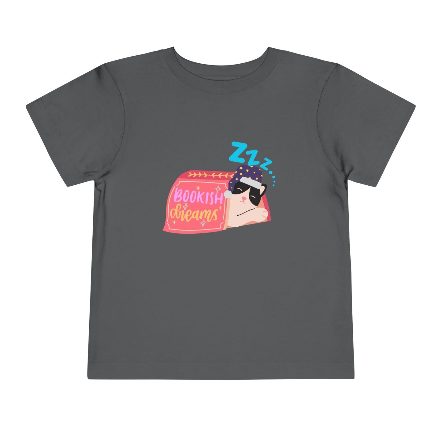 Gray toddler t-shirt with a snoozing cat in a night cap, under a book and text 'Bookish Dreams'