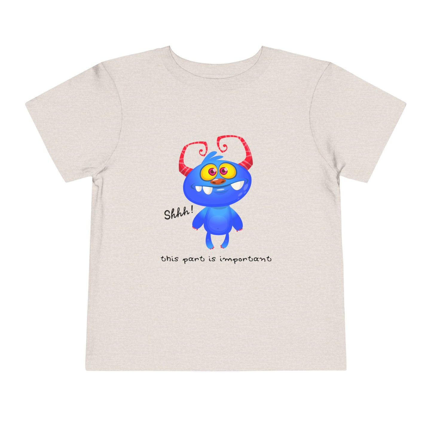 Tan toddler t-shirt with a blue monster and text 'shhh! this part is important'