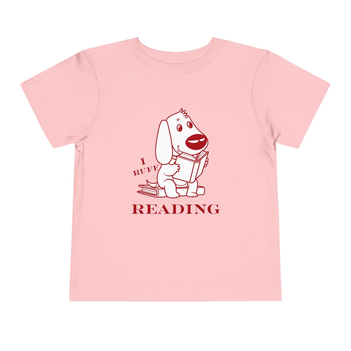Pink toddler t-shirt with red and white graphic of a dog reading a book and text 'I RUFF READING'