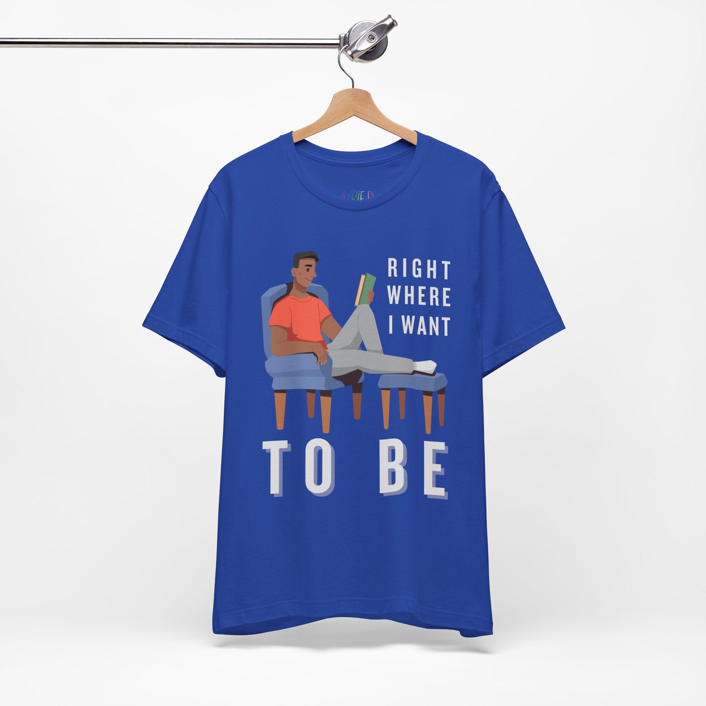 Blue t-shirt with a man lounging in a chair, feet up, book in hand and text 'Right Where I Want To Be'
