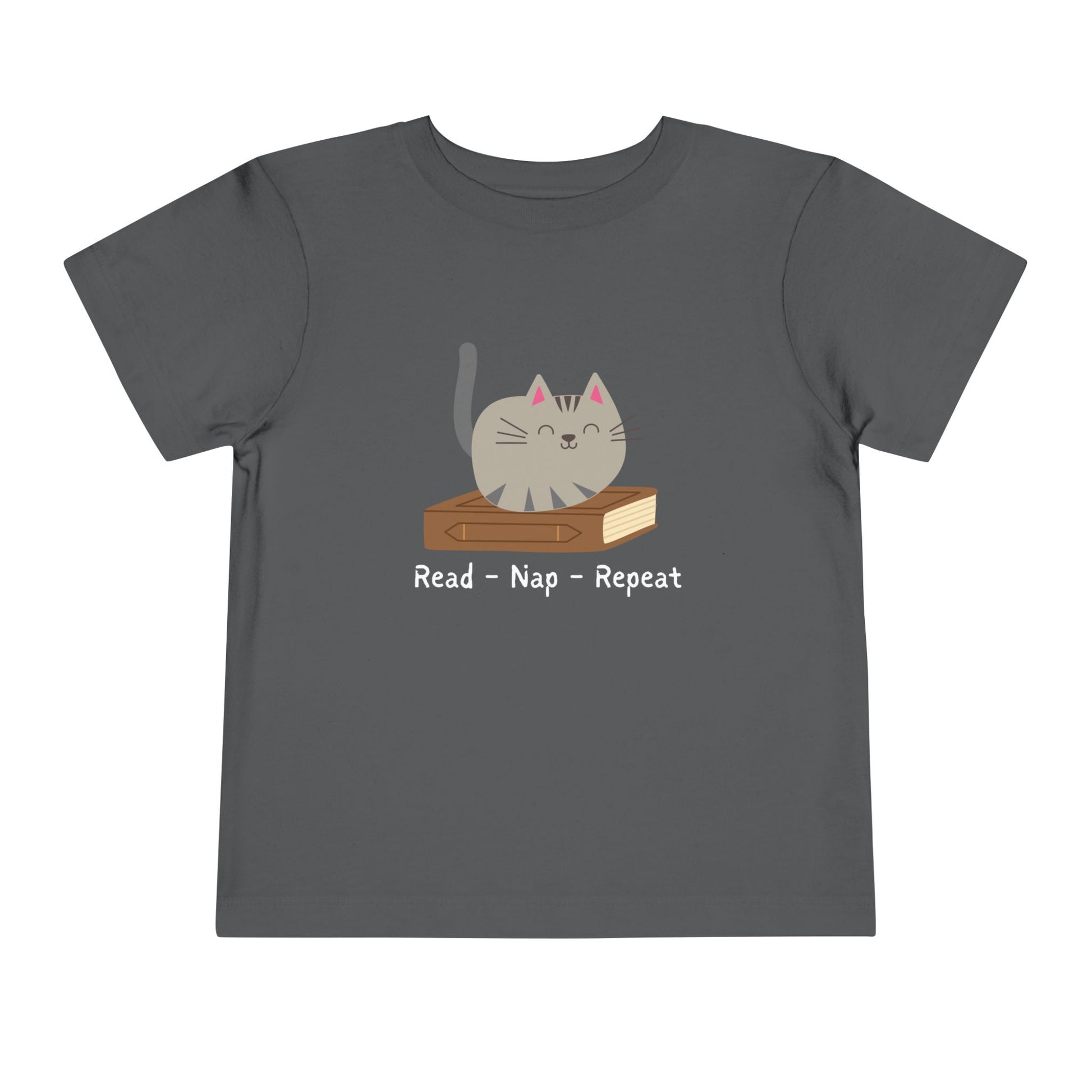 Gray t-shirt with a gray cat sitting on top of a brown boo, text 'Read - Nap - Repeat'