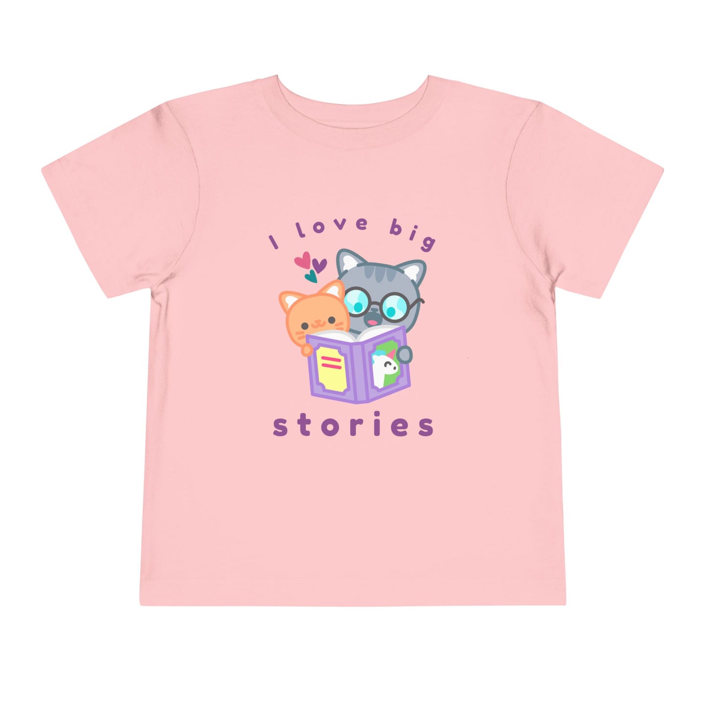 Pink toddler t-shirt with cartoon cats reading a unicorn book and 'I love big stories' text