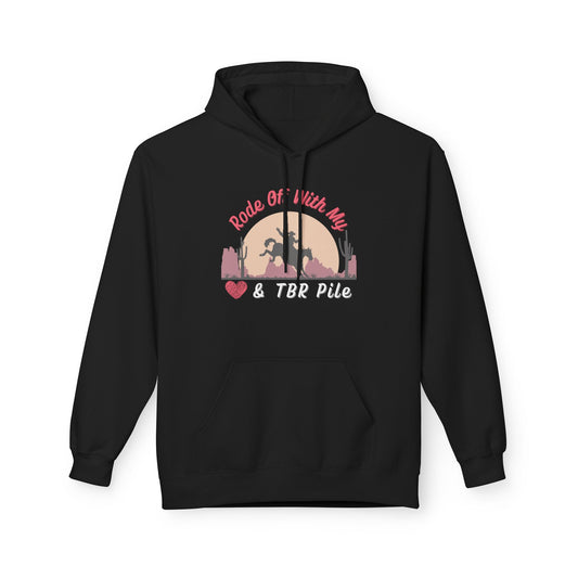 Black hoodie with a western sunset design showing a cowboy on horseback and text that reads “Rode Off With My Heart & TBR Pile.”