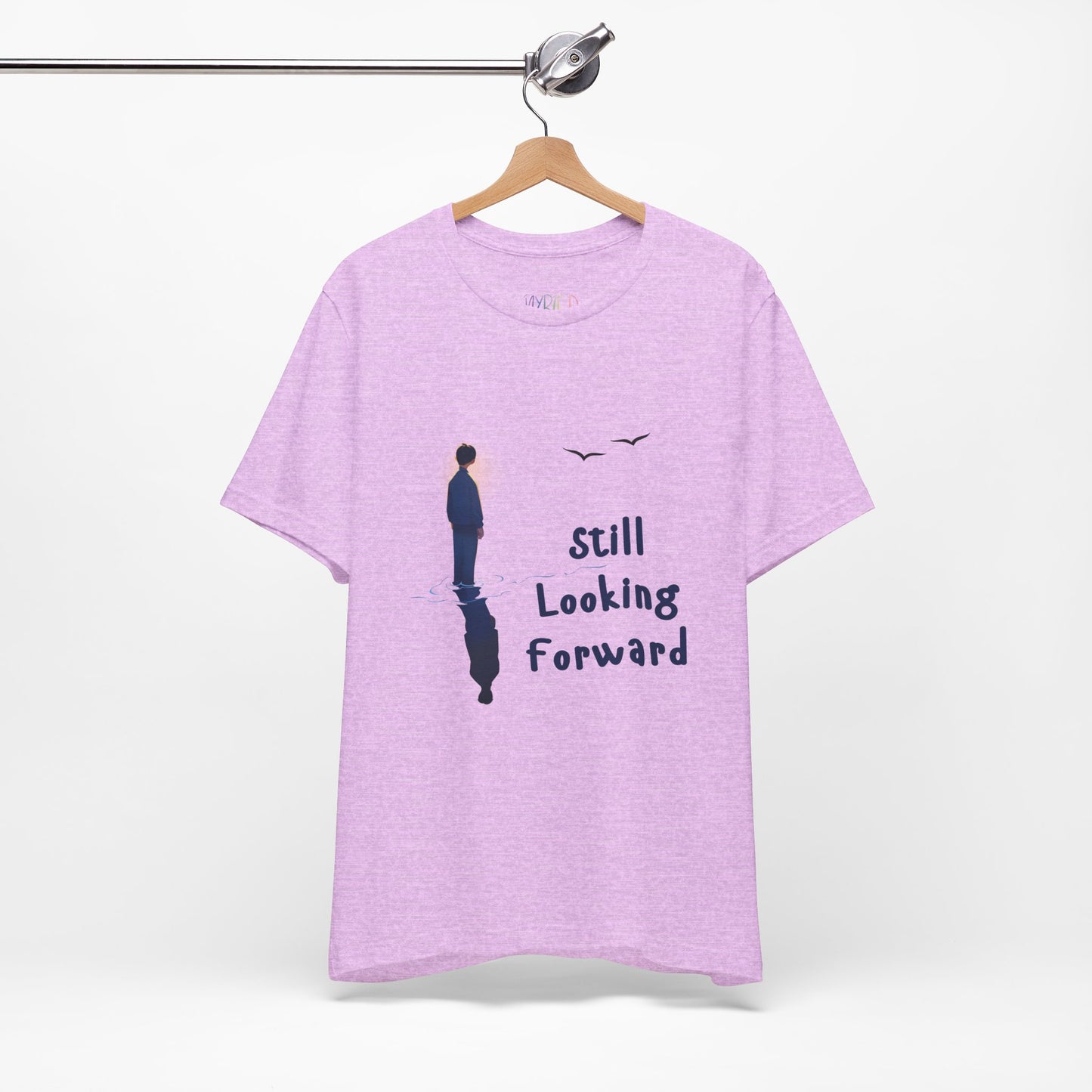 Light purple t-shirt with graphic of a person standing in the water with his reflection and text 'Still Looking Forward'