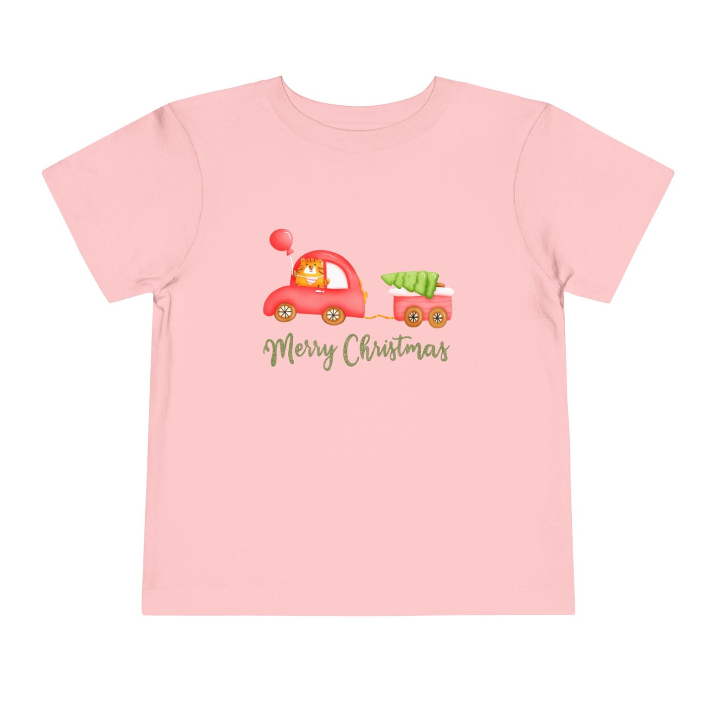 Pink toddler t-shirt with a tiger driving a red car, pulling a tailer with a Christmas tree and text 'Merry Christmas' on a white background