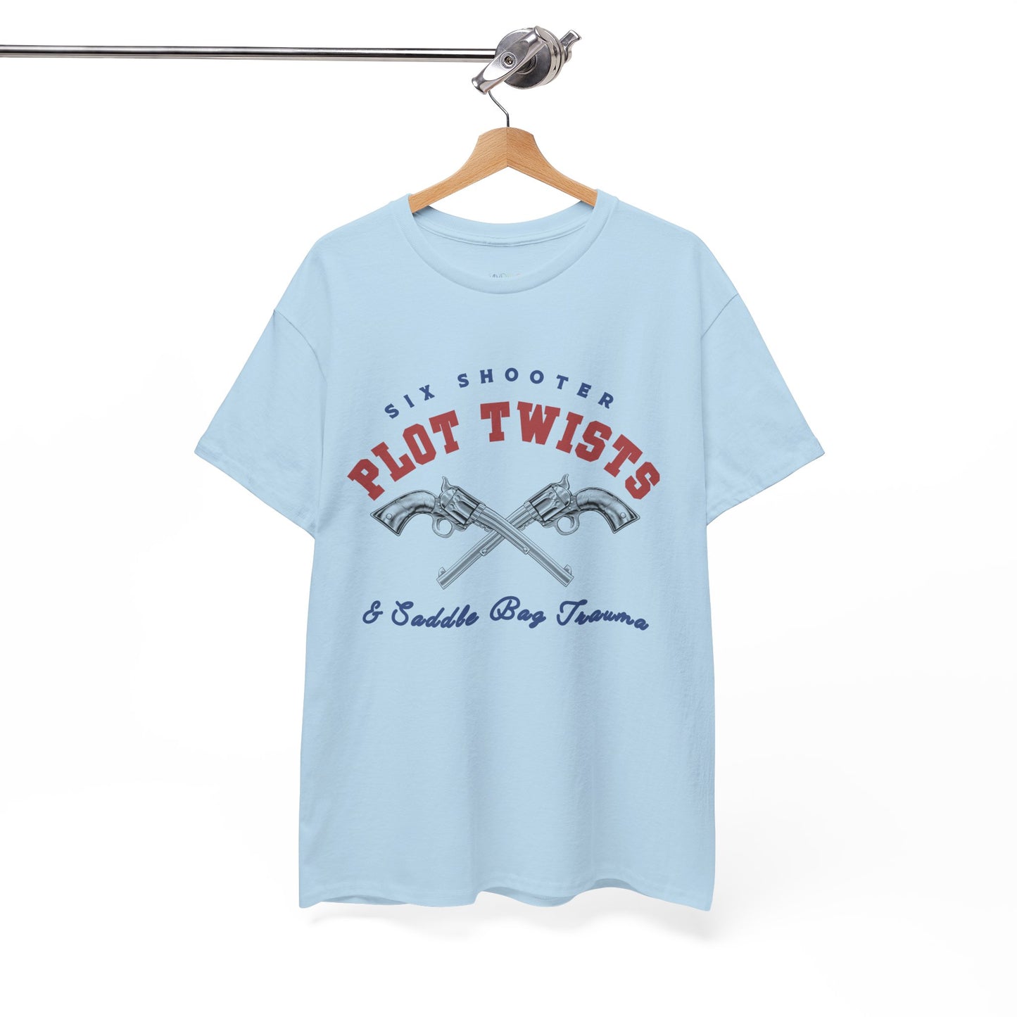Light blue t-shirt with two pistols criss-crossed in the center and text 'Six Shooter Plot Twists & Saddle Bag Trauma'