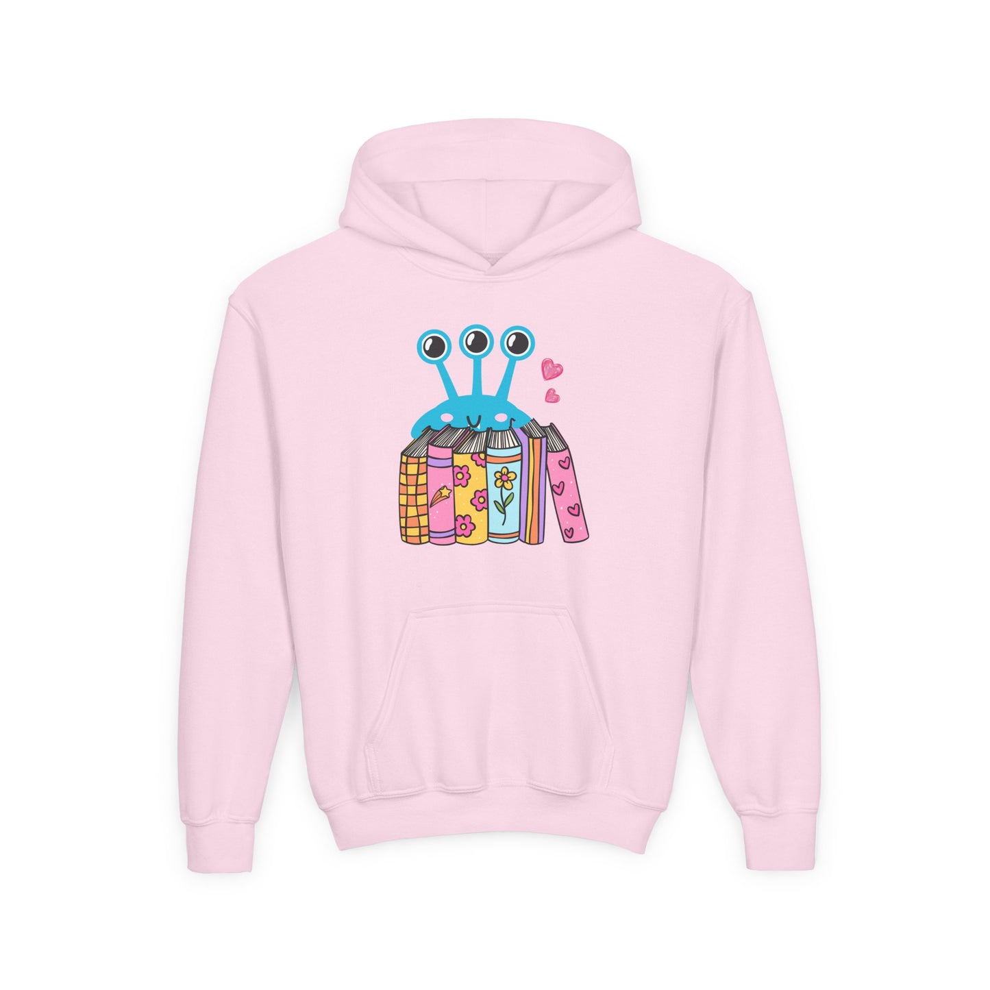 Pink hoodie with a three eyed alien standing behind a row of books