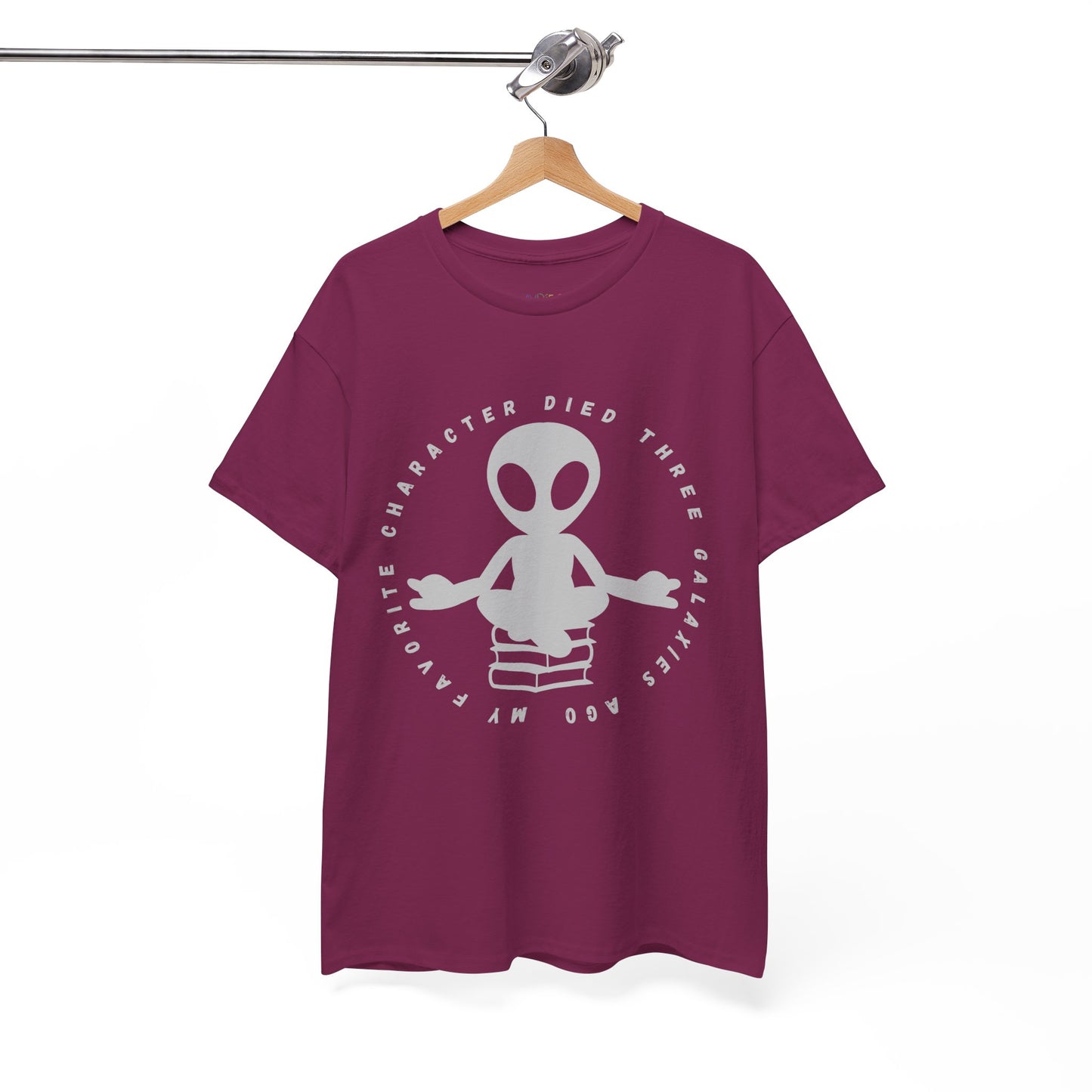 Berry t-shirt with meditating alien sitting on a stack of books, circled by text 'My Favorite Character Died Three Galaxies Ago'