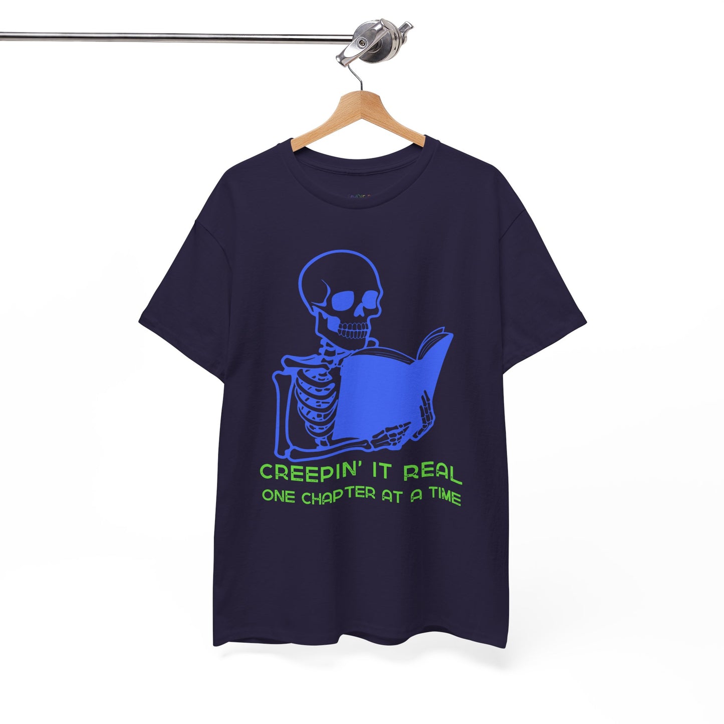 Blackberry t-shirt with blue skeleton graphic reading a book and green text 'Creepin' It Real One Chapter At A Time' on a hanger against a white background