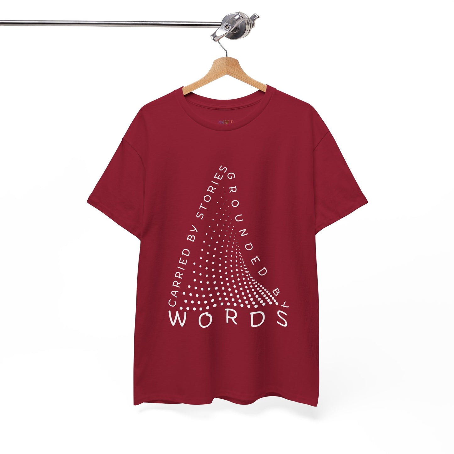 Red t-shirt with white text that follow the outline of a dotted triangle 'Carried By Stories, Grounded By Words'