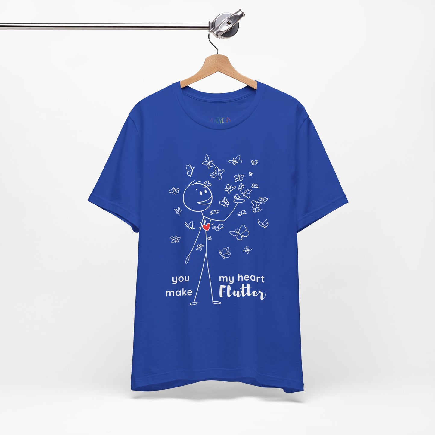 Blue t-shirt with a stick figure surrounded by butterflies and a red heart beating on his chest, text 'You Make My Heart Flutter'