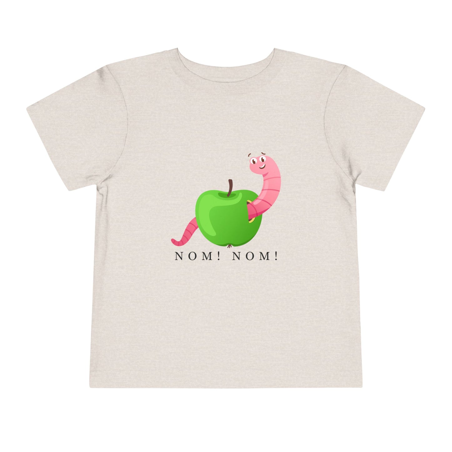 Tan toddler t-shirt with a green apple and pink worm graphic and 'NOM! NOM!' text
