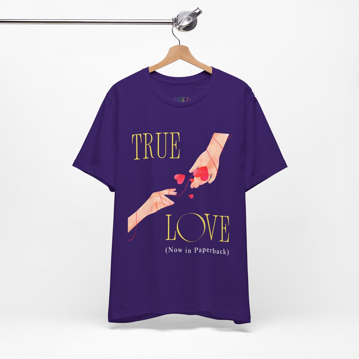 Purple t-shirt with 'True Love (Now in Paperback)' text and graphic of two hands reaching foreach other, entwined in red string and hearts