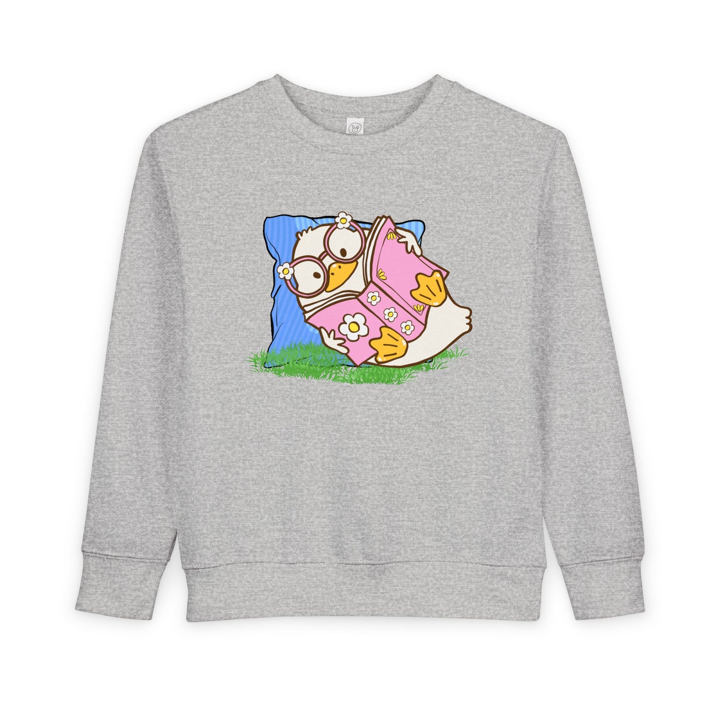 Light gray toddler duck reading a book in the grass on a comfy pillow sweatshirt