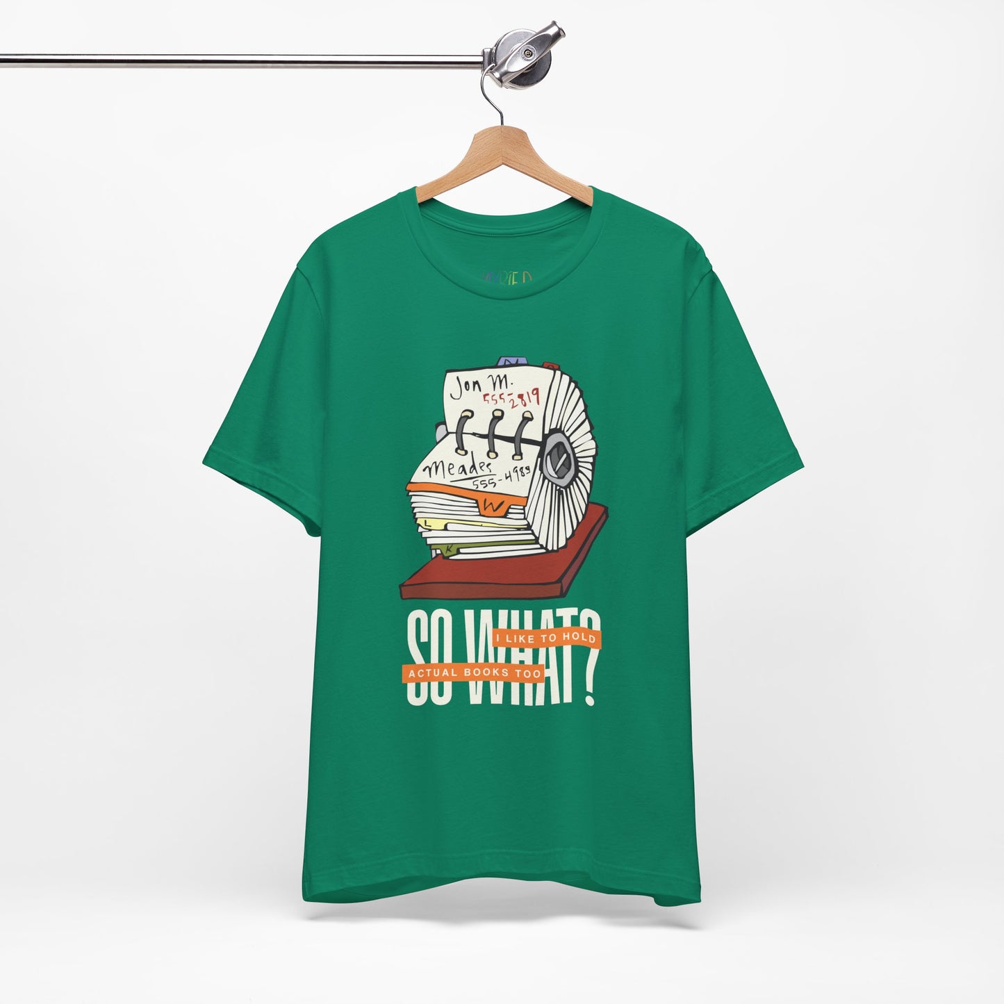 Green t-shirt with a graphic design of a rolodex and text 'So What, I Like To Hold Actual Books Too'