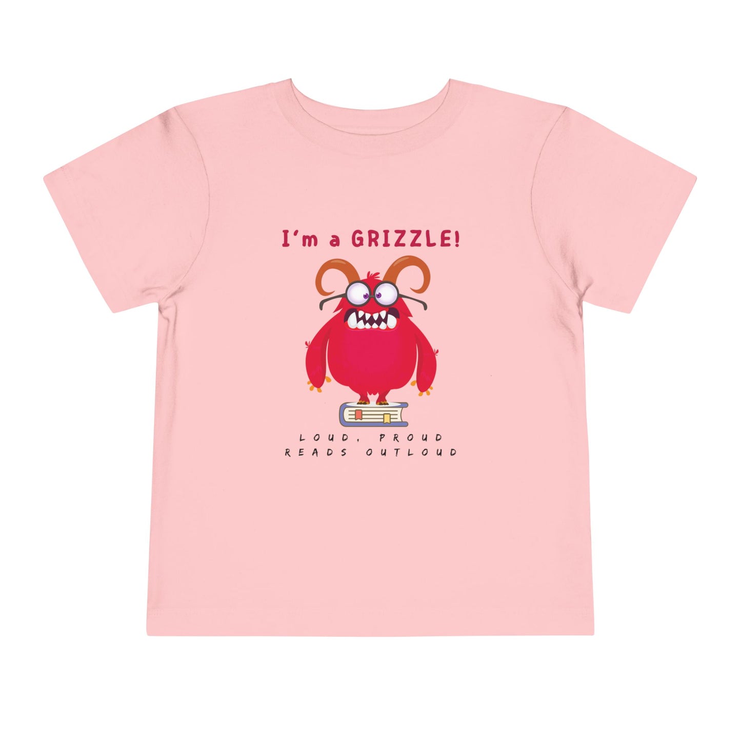 Pink toddler personality t-shirt with a red monster graphic standing on a book proudly proclaiming 'I'm a GRIZZLE!' Sub-text 'Loud, Proud, Reads Aloud.'