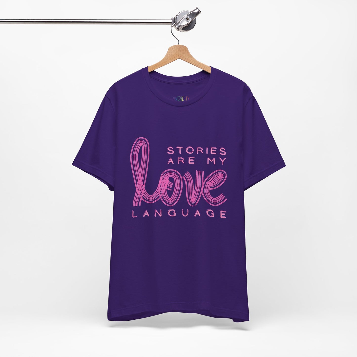 Purple t-shirt with pink text 'Stories Are My Love Language'