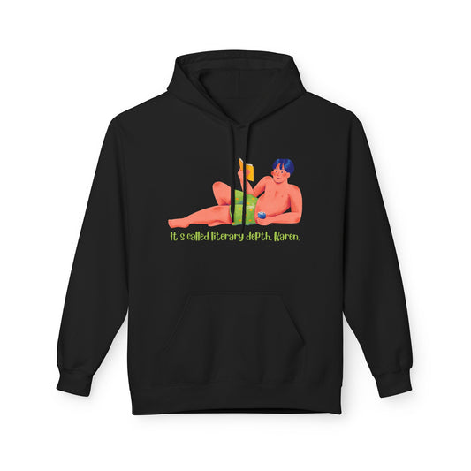 Black hoodie featuring an illustrated person lounging behind stacked books with the phrase “It’s called literary depth, Karen.” in green text.