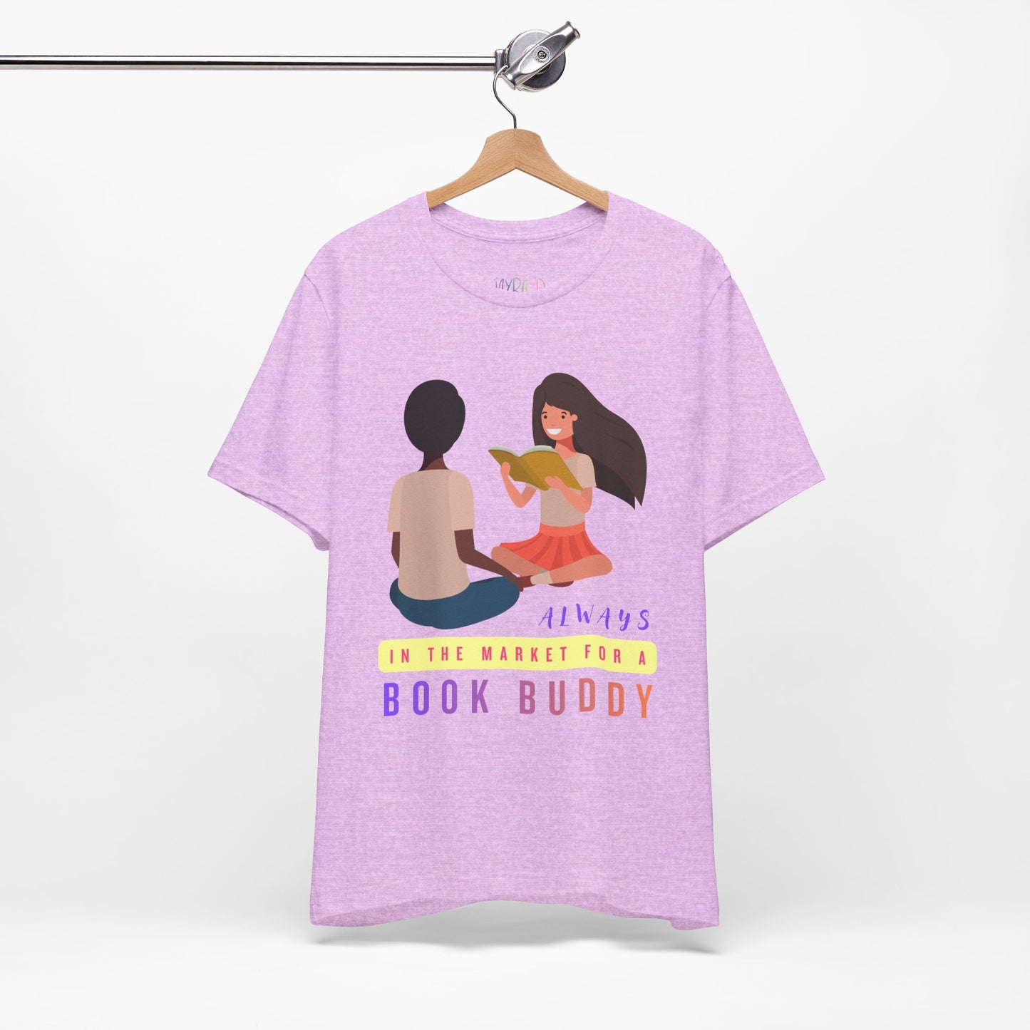 Light purple t-shirt with graphic of two people reading together and text 'Always in the market for a book buddy'