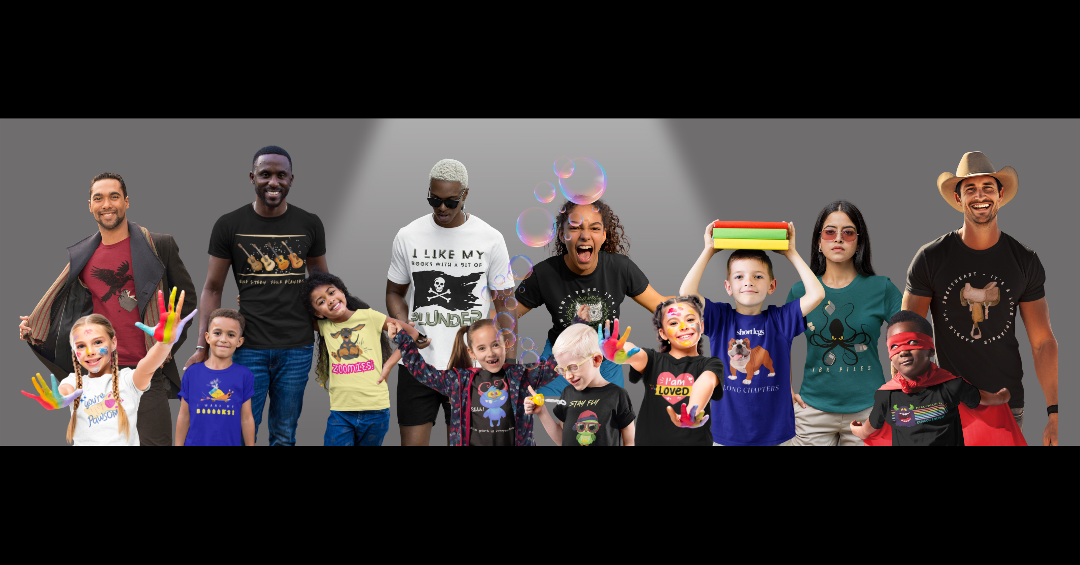 Group of people and children wearing colorful bookish t-shirts with various bookish designs by Jaybie D., pictured on a lighted gray background