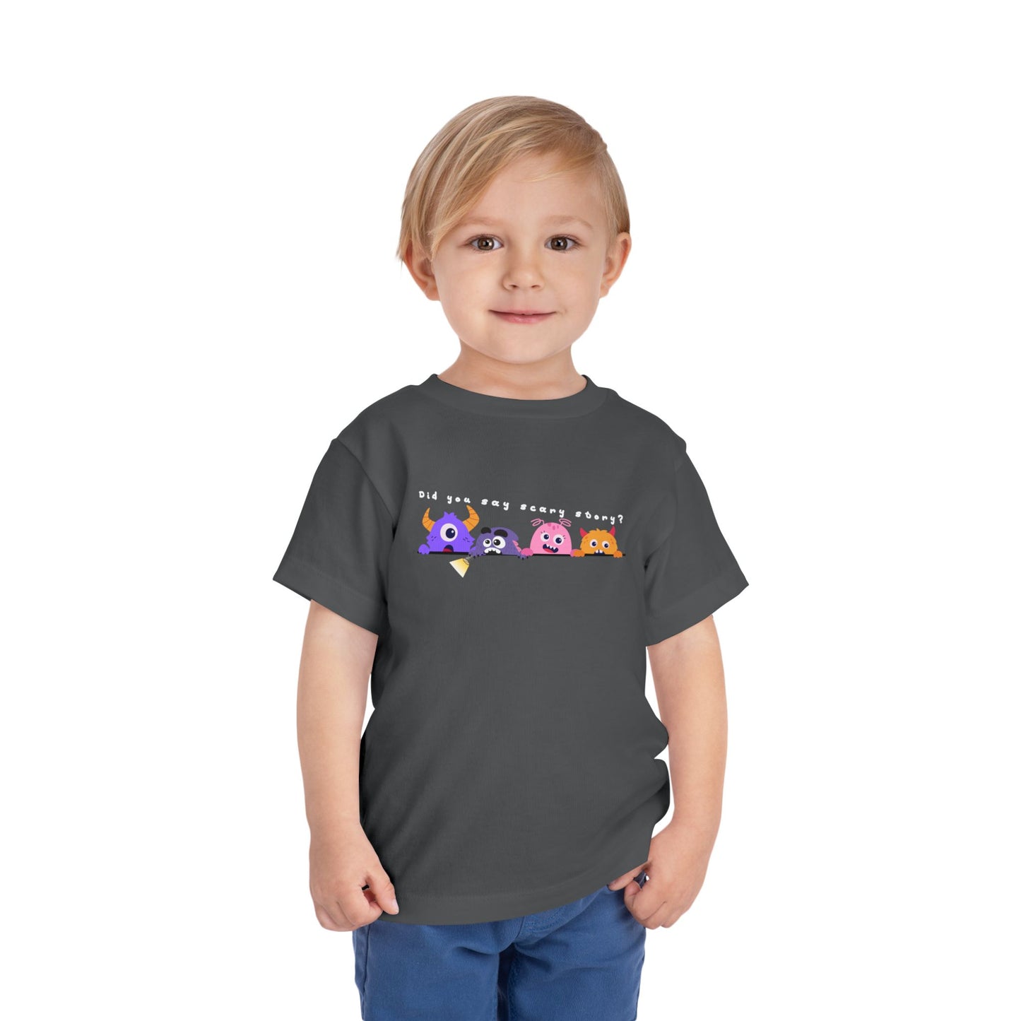 Toddler wearing a gray t-shirt with a row of scared cartoon monsters peeking over a ledge and text 'Did You Say Scary Story?'