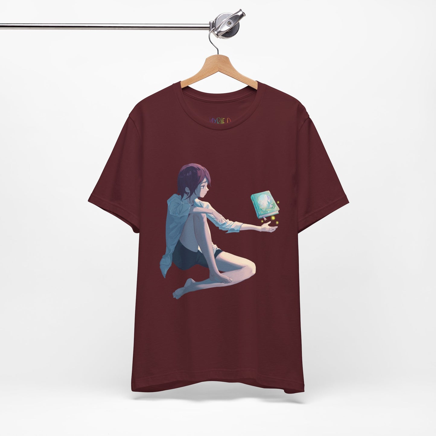 Maroon t-shirt with a fantasy illustration of a person holding their palm up as a book magically floats above it