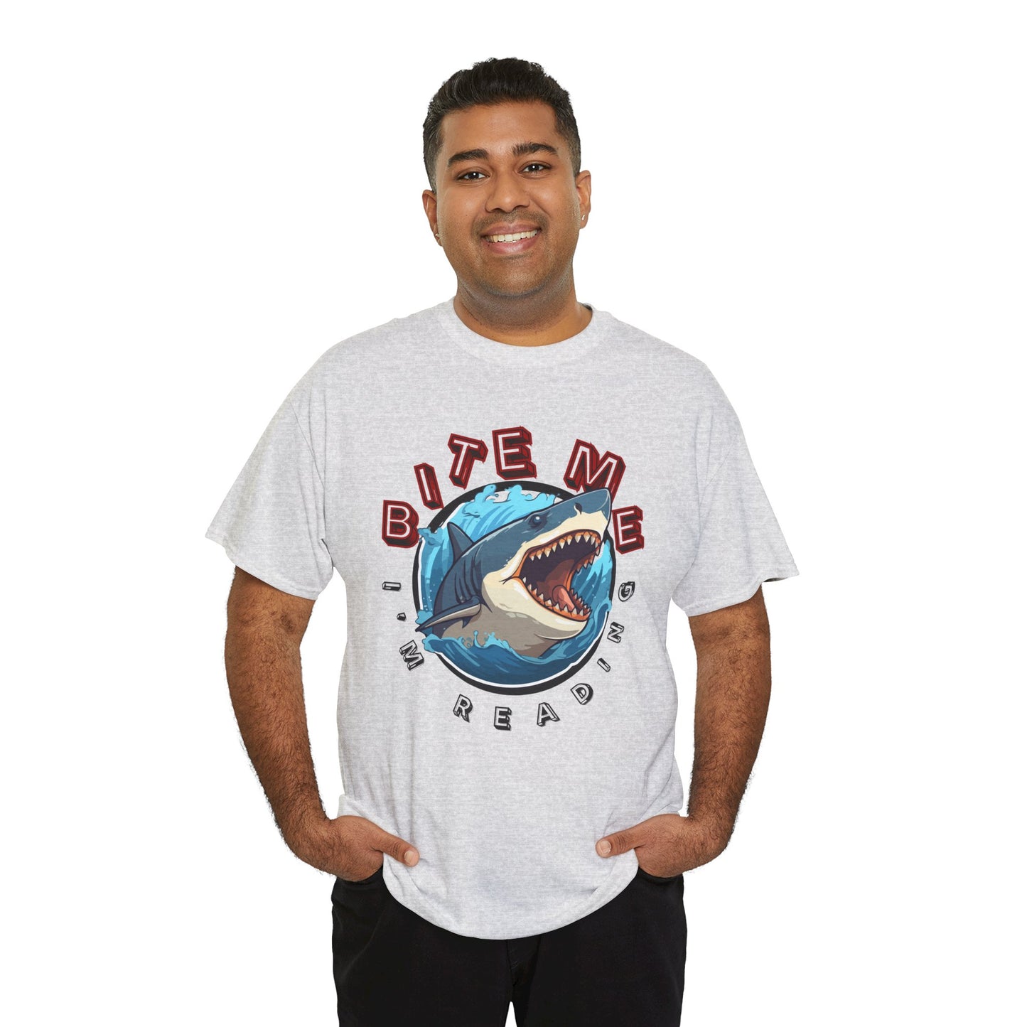 Man waring a gray t-shirt with a shark graphic bursting out of the center and text 'Bite Me I'm Reading' 