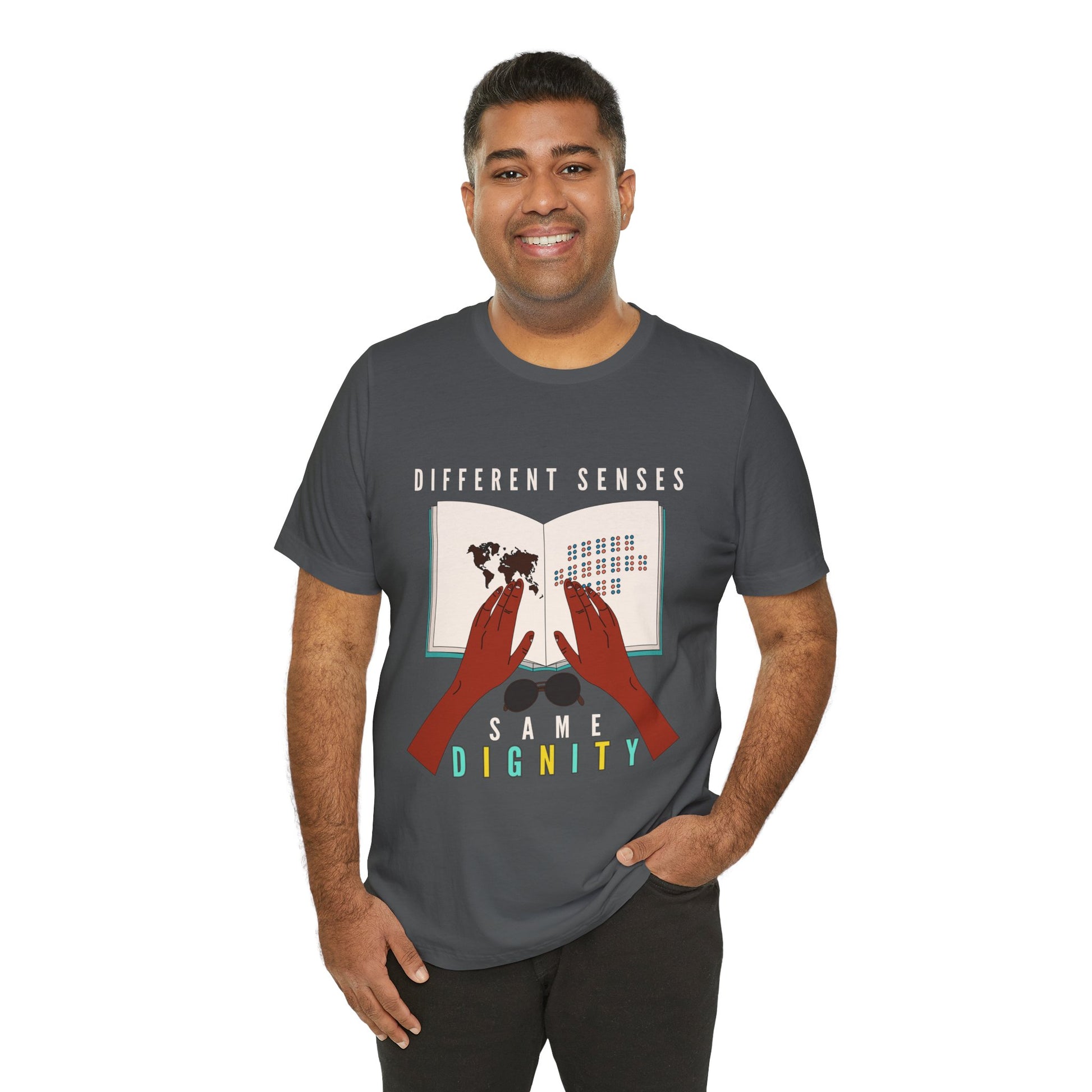 Man wearing a gray t-shirt with graphic of two hands touching a braille book and text 'Different Senses, Same Dignity'