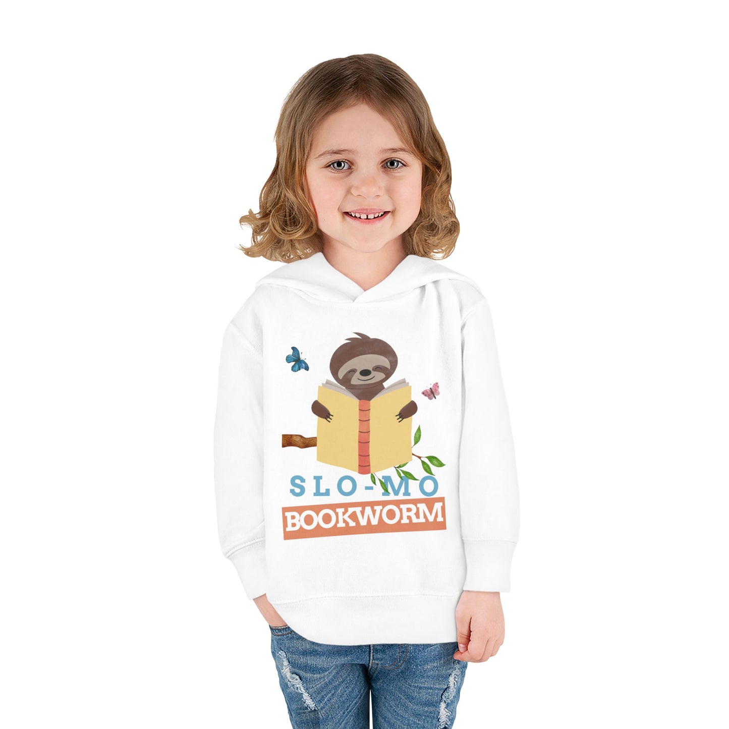Girl wearing a white toddler hoodie with a sloth reading a book graphic and 'SloMo Bookworm' text 