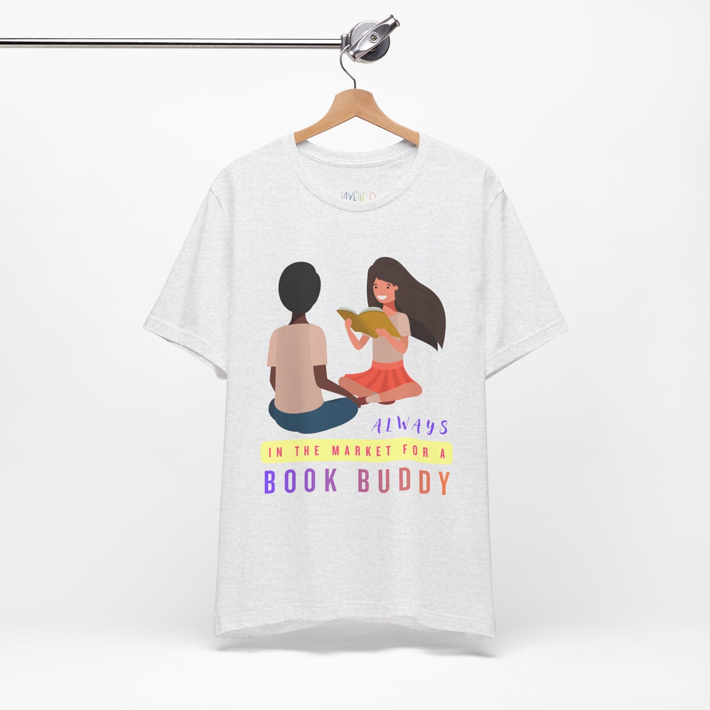 Light gray t-shirt with graphic of two people reading together and text 'Always in the market for a book buddy' 