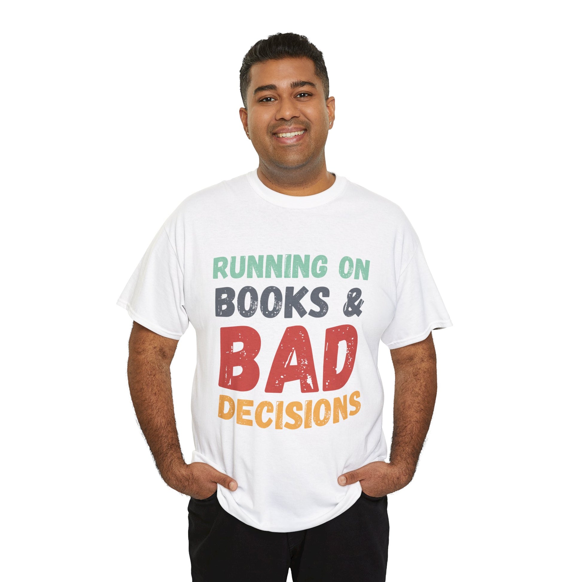 Man wearing a white t-shirt with colorful retro text 'Running on Books & Bad Decisions' 