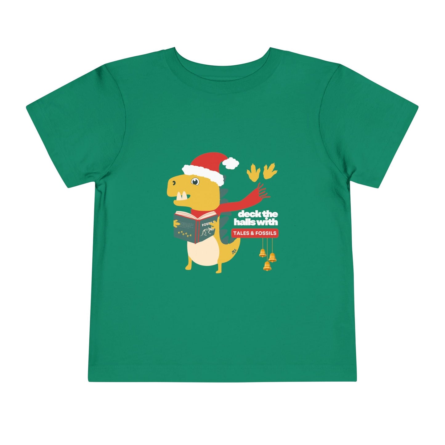 Green toddler t-shirt with a Christmas-themed dinosaur graphic reading or singing from a book, and text 'deck the halls with tales & fossils' on a white background