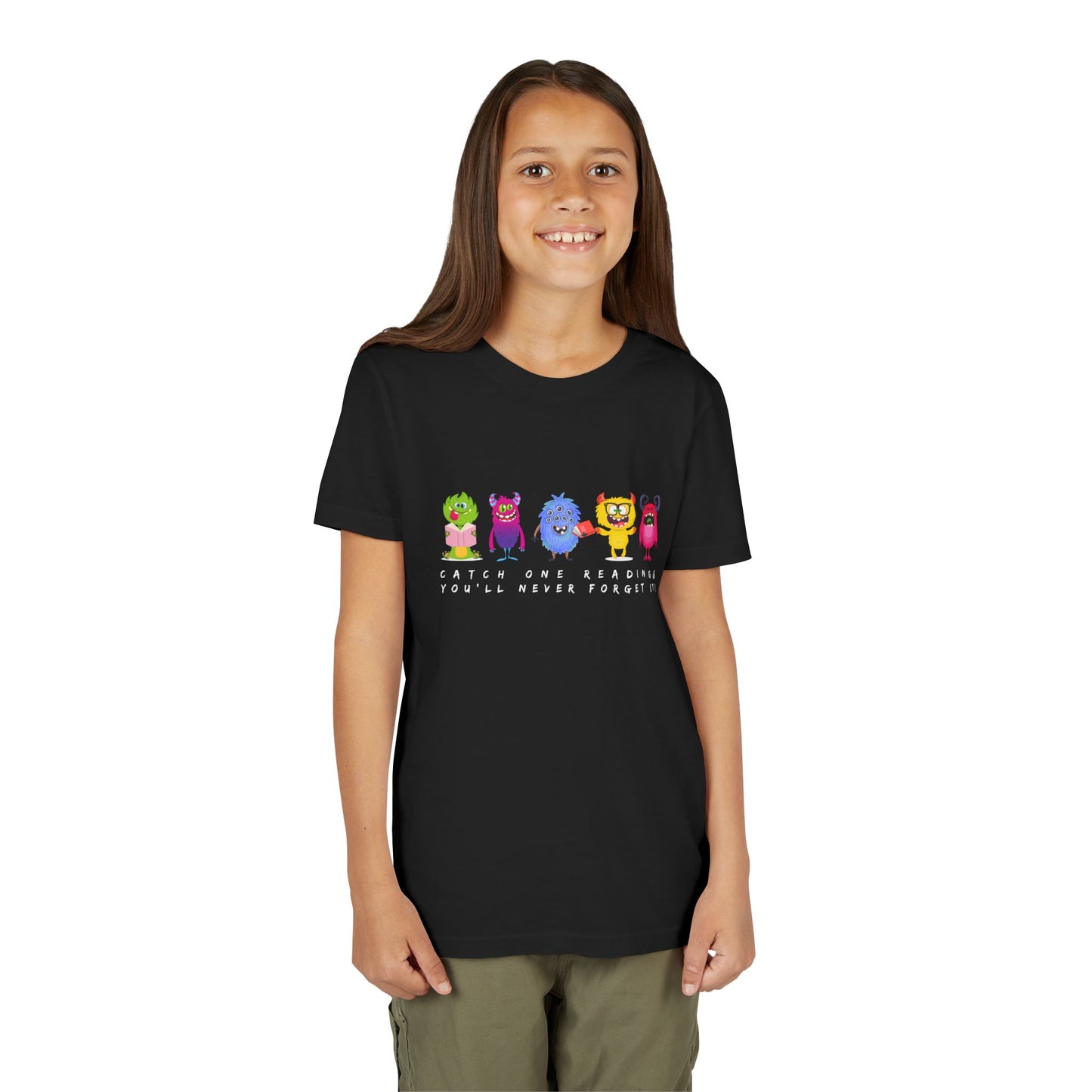 Girl wearing a black t-shirt with a row of colorful cartoon monster characters and text 'Catch One Reading & You'll Never Forget It'
