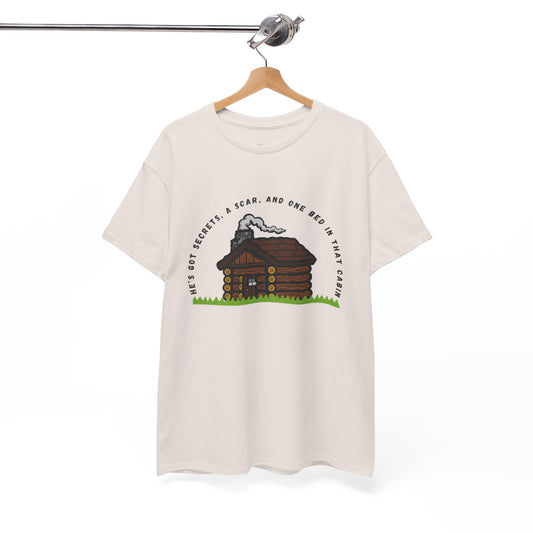 Ice gray t-shirt with cabin graphic and text 'He's Got Secrets, A Scar, And One Bed In That Cabin'