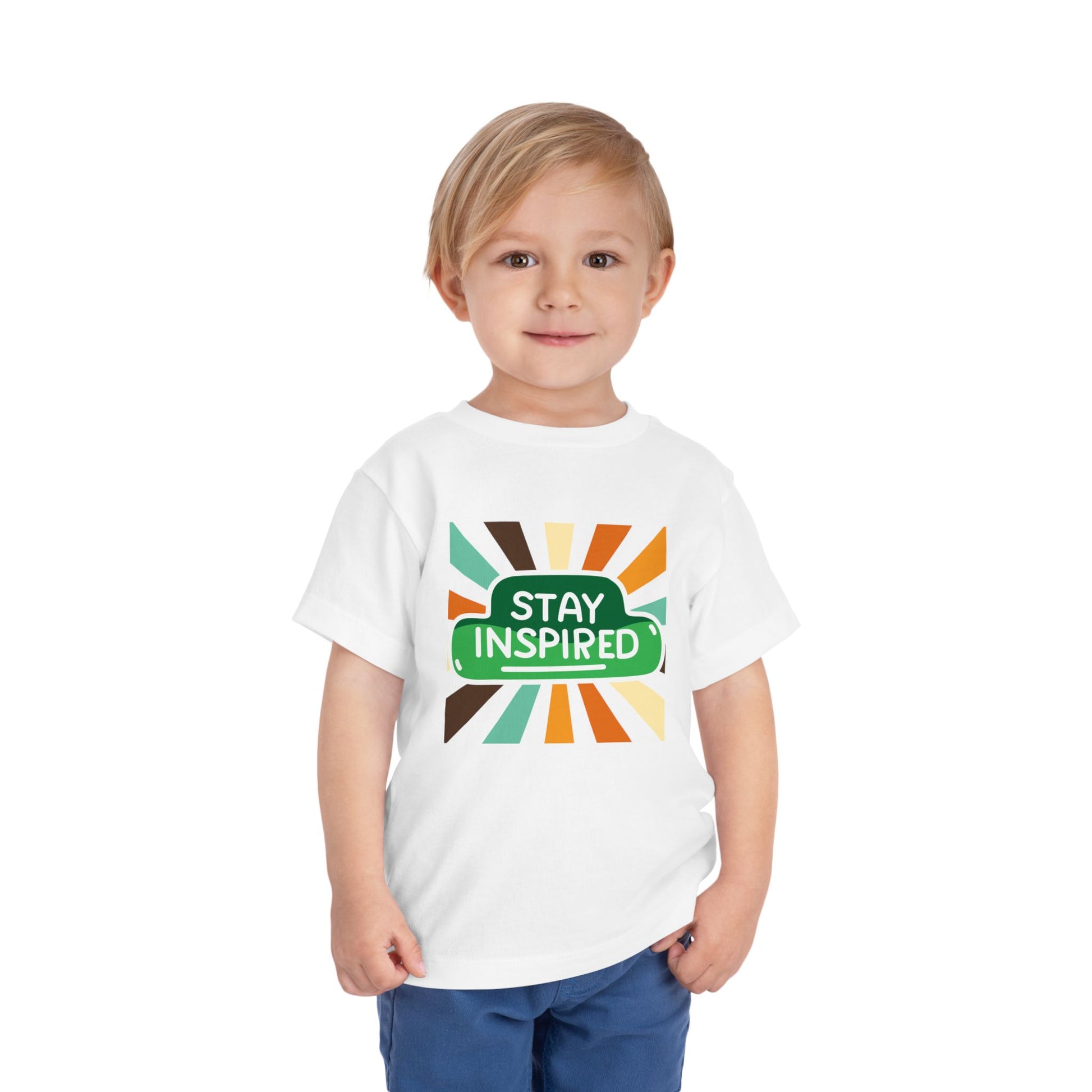 Toddler wearing a white t-shirt with 'Stay Inspired' graphic design with fun retro stripes