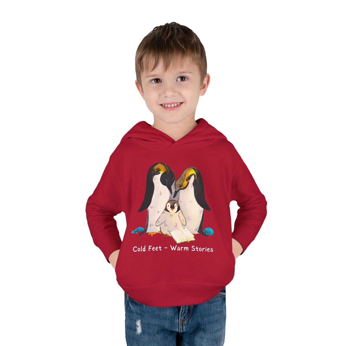 Boy wearing a red hoodie of a penguin family and text 'Cold Feet - Warm Stories'