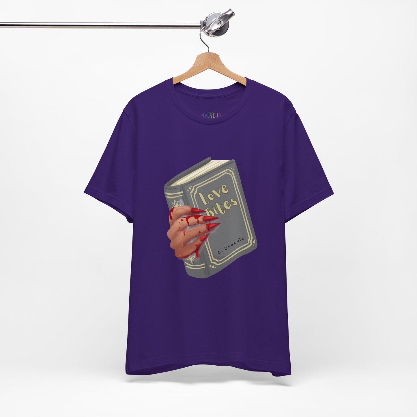 Purple t-shirt with graphic design of a creepy and bloody hand holding a book titled 'Love Bites' by C. Dracula