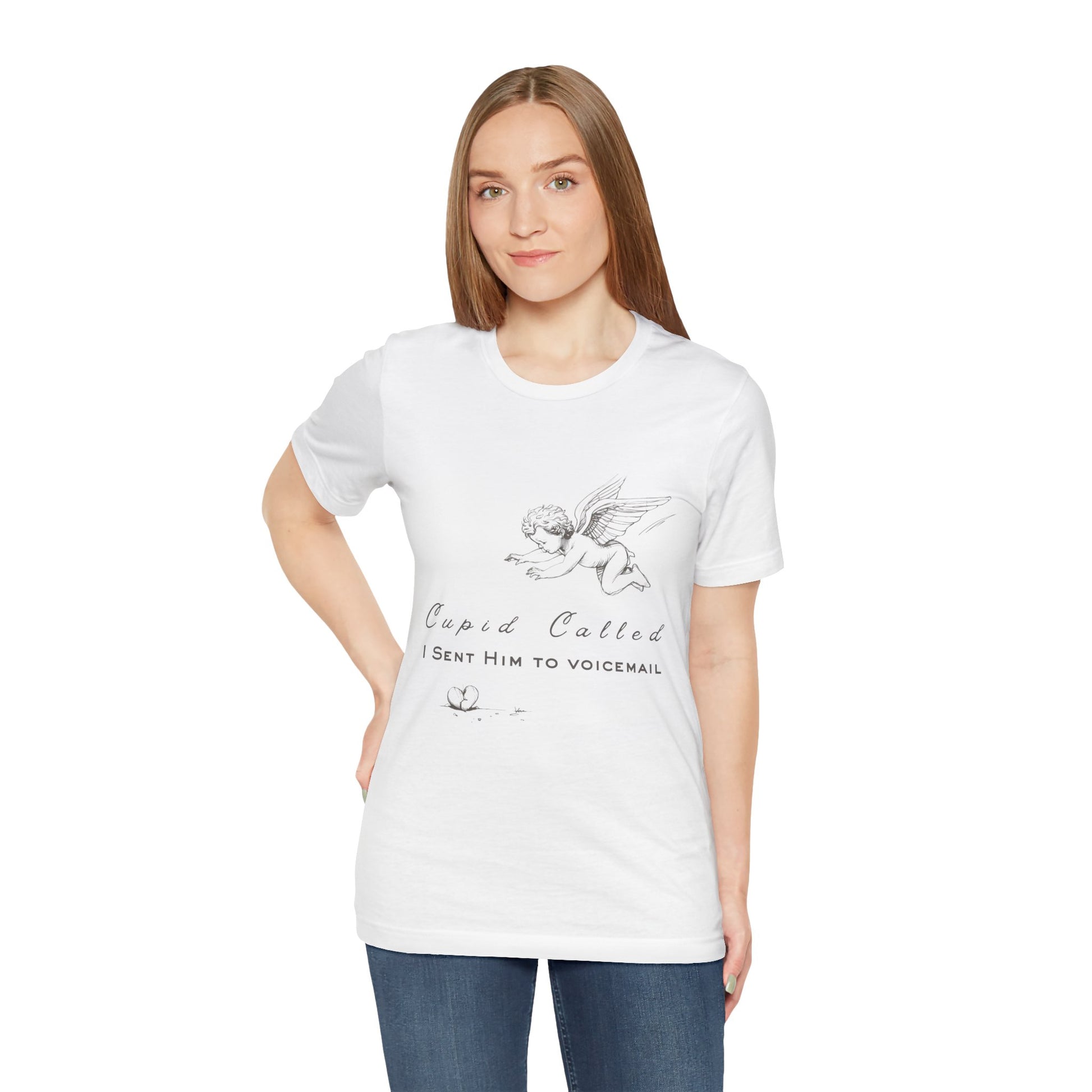 Woman wearing a white t-shirt with cupid graphic design, a broken heart on the floor and text 'Cupid Called. I Sent Him To Voicemail.'