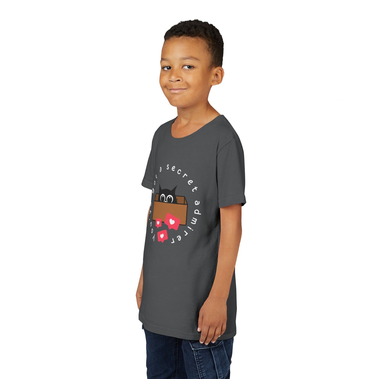 Boy wearing a gray t-shirt with a graphic of a cat peeking out of a box, heart social media bubbles and text 'You've Got A Secret Admirer' 