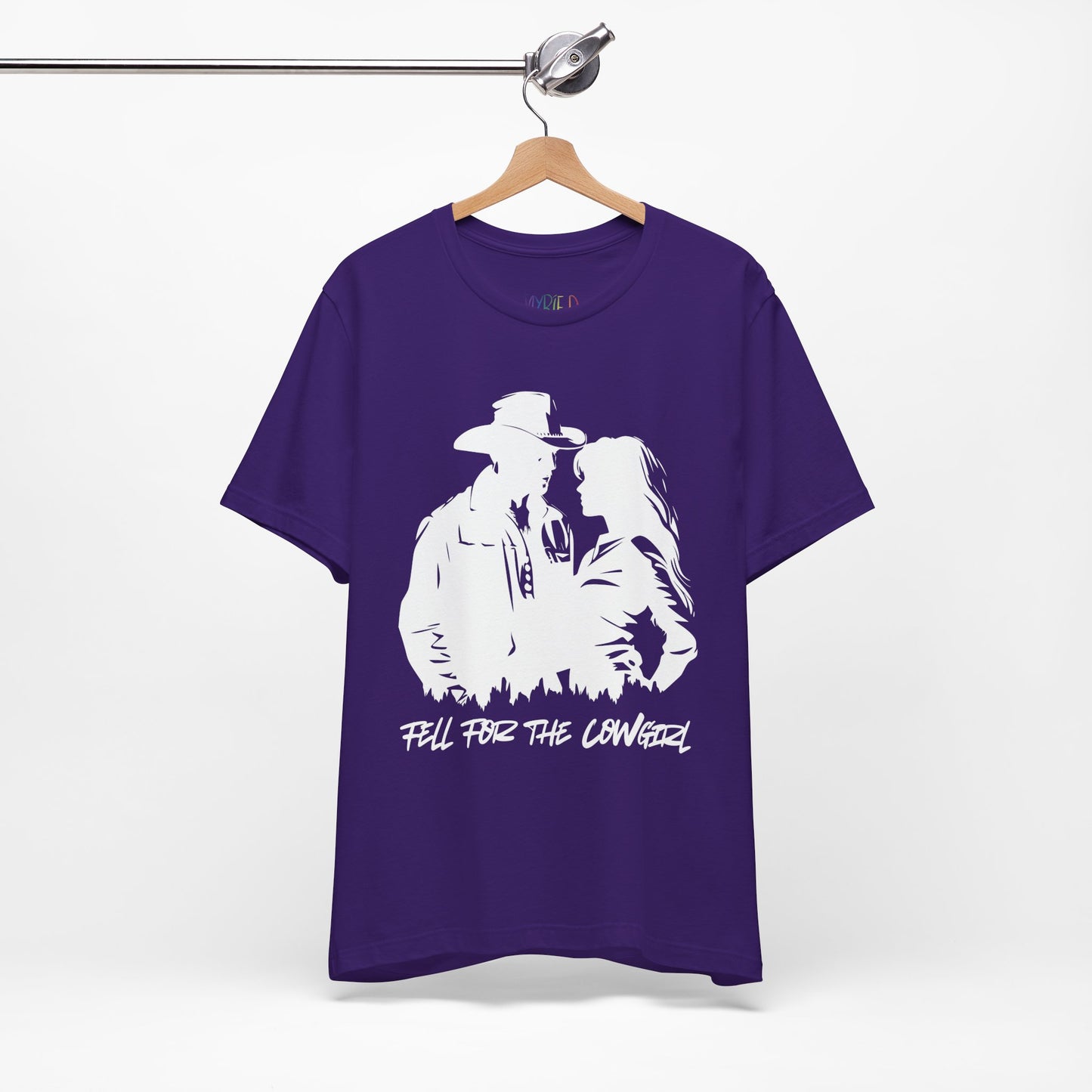 Purple t-shirt with white graphic of a man and a woman, text says 'Fell for the Cowgirl'