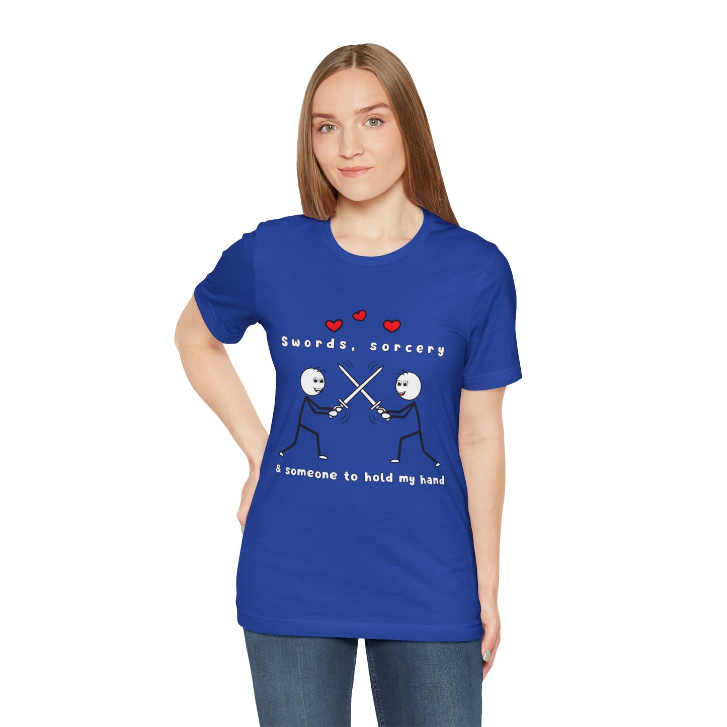 Woman wearing a blue t-shirt with graphic design of two smiling stick figures sword fighting and text 'Swords, Sorcery & Someone To Hold My Hand'