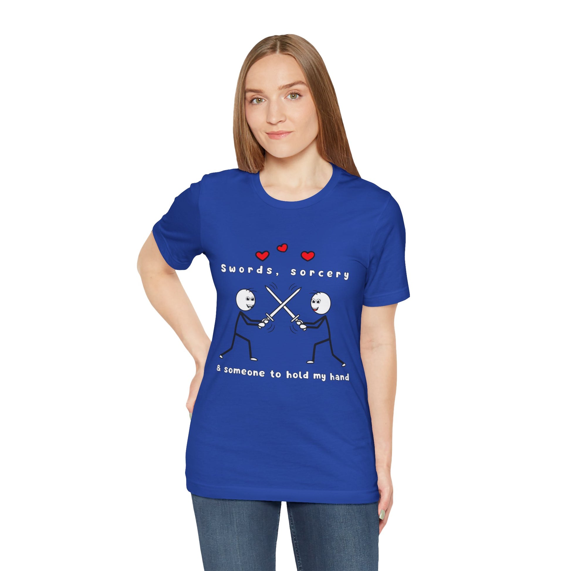 Woman wearing a blue t-shirt with graphic design of two smiling stick figures sword fighting and text 'Swords, Sorcery & Someone To Hold My Hand'