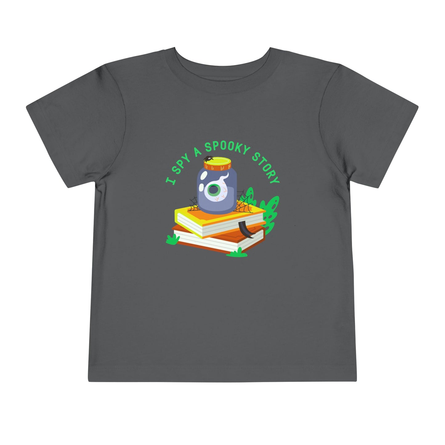 Gray toddler t-shirt with an eyeball in a yar on top of books and text 'I spy a spooky story' on a white background
