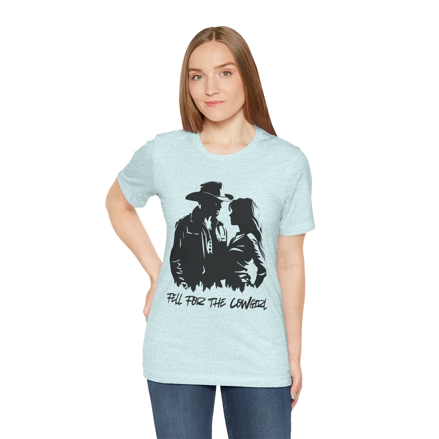 Woman wearing a light blue t-shirt with black graphic of a man and a woman, text says 'Fell for the Cowgirl'