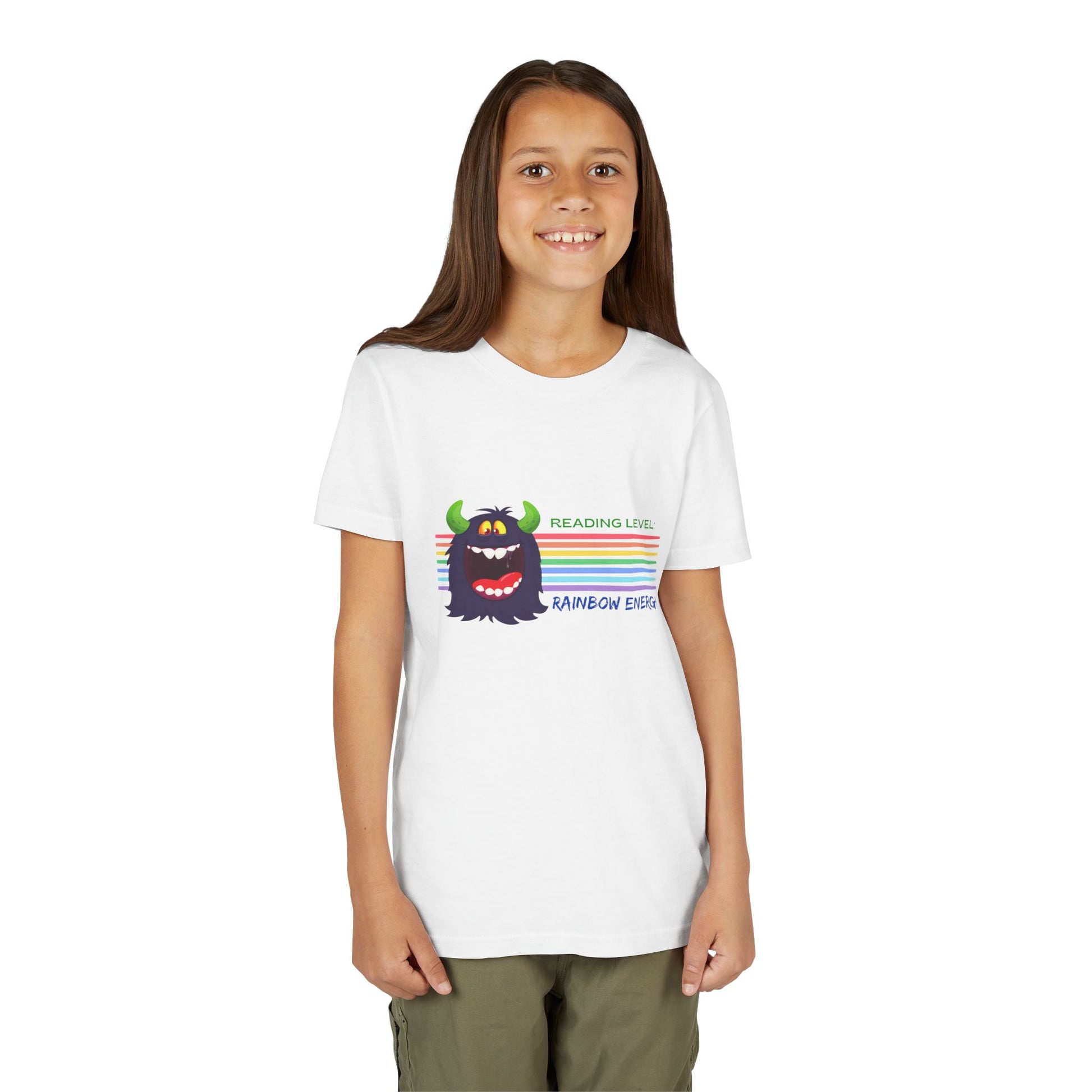 Girl wearing a white t-shirt with a cartoon monster, horizontal rainbow strips and text 'Reading Level: RAINBOW ENERGY' 