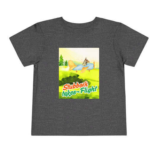 Gray toddler t-shirt with a colorful graphic of a a donkey flying an airplane, with text 'Stubborn takes Flight' 