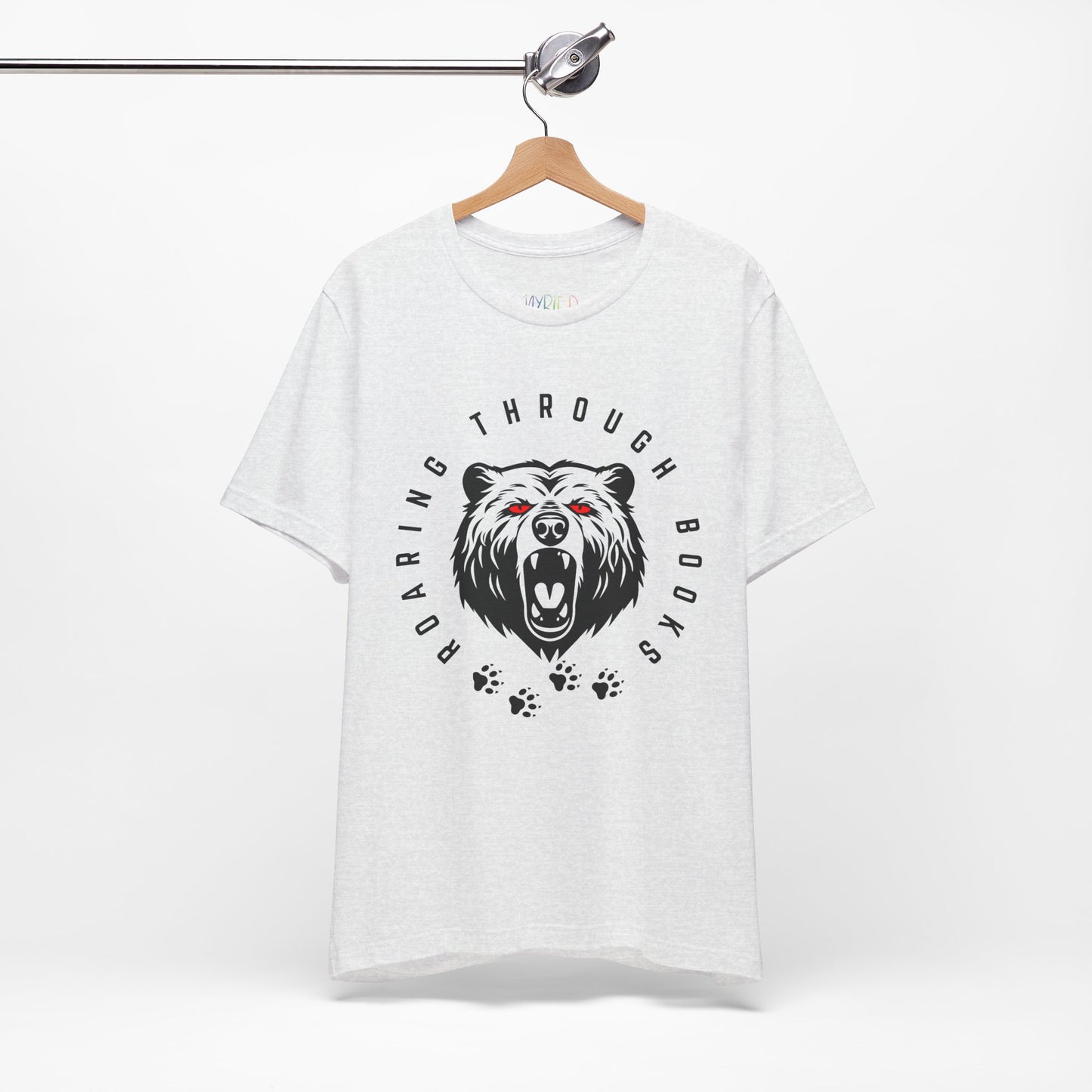 Light ash gray t-shirt with a black bear graphic, red eyes and circular text 'Roaring Through Books'