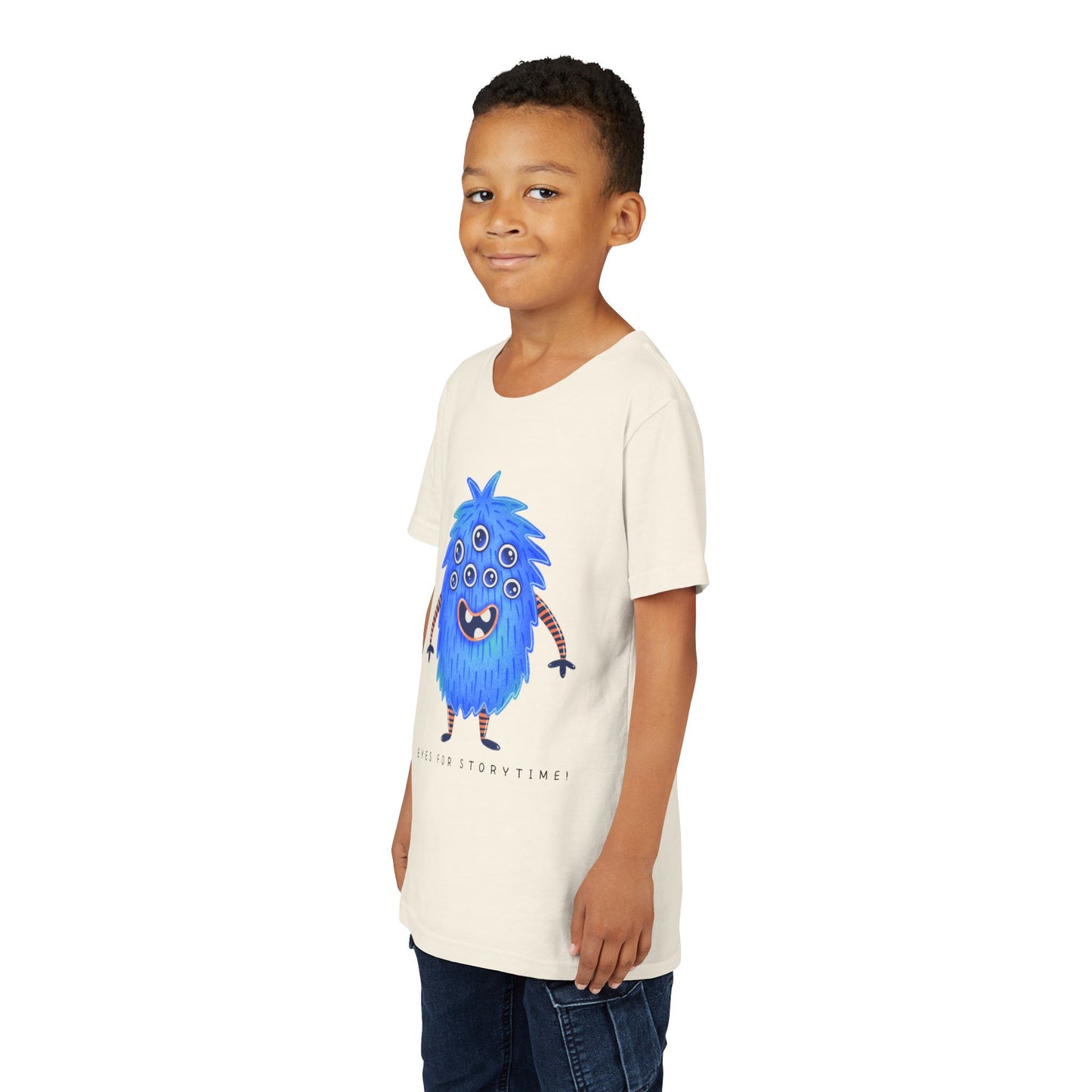 Boy wearing a beige t-shirt with a multi-eyed blue monster graphic and text 'Eyes For Storytime'