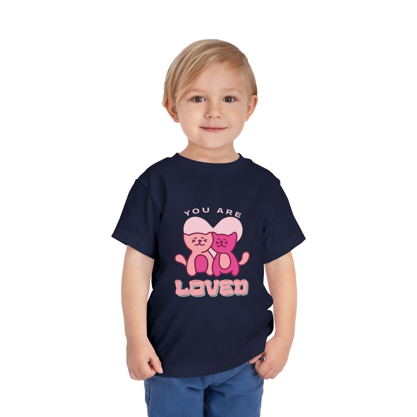 Child wearing a navy blue toddler t-shirt with two pink cats and 'You are loved' text 